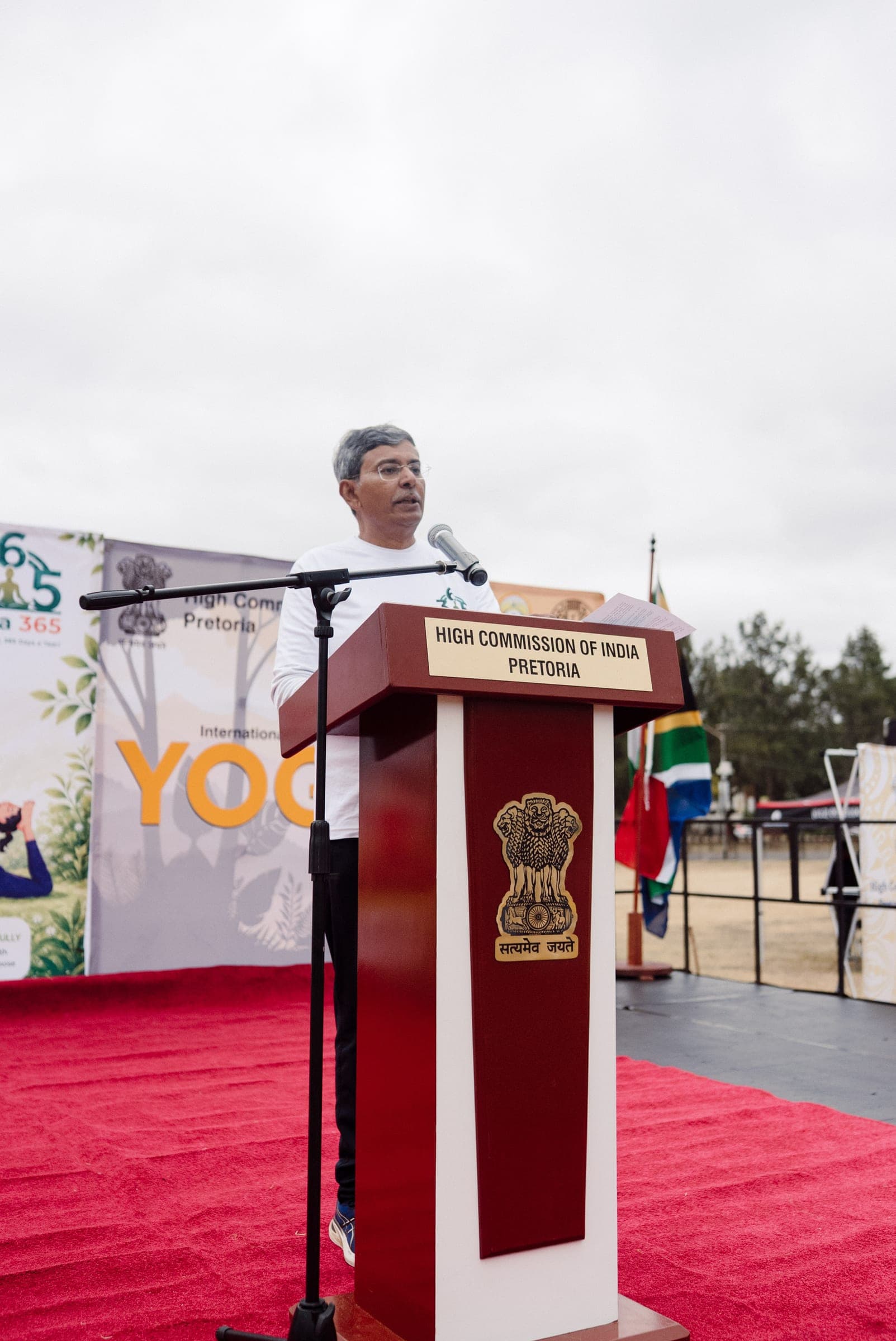 Speaker at the High Commission of India Pretoria podium during Yoga Day