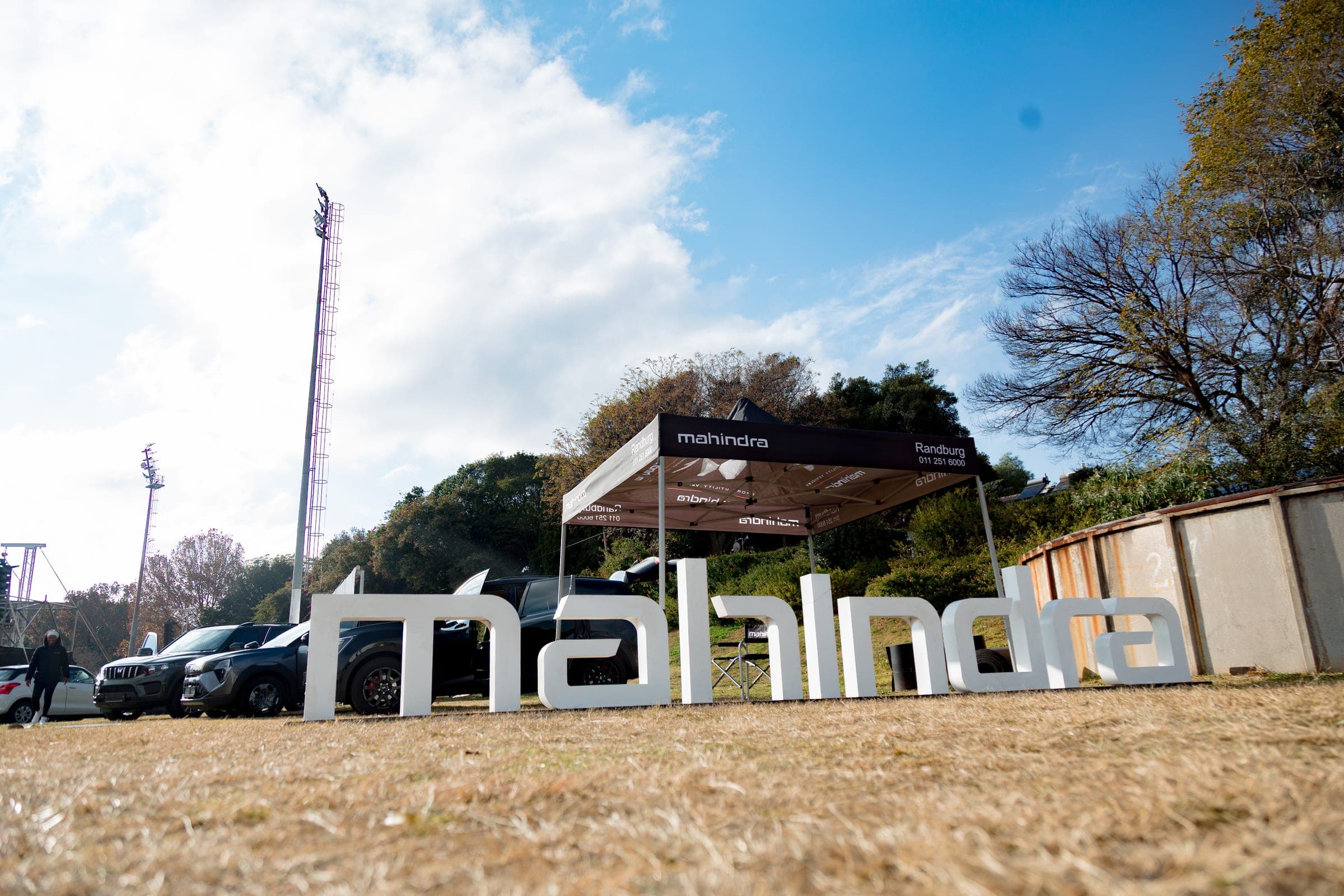 Large white three-dimensional Mahindra letters on the grass field