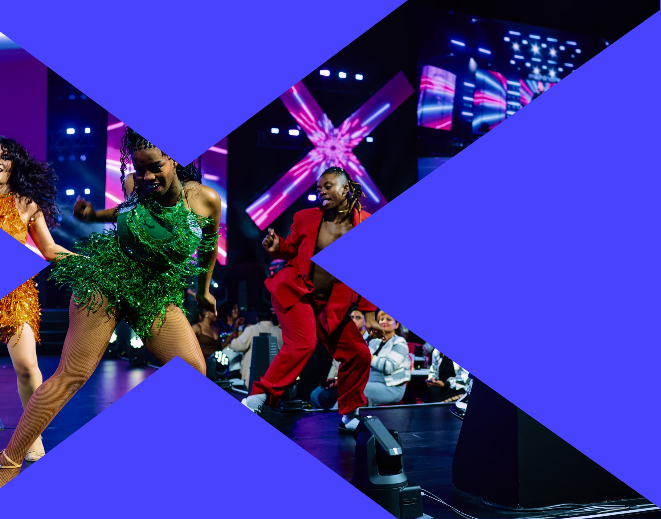 Dancers on the Fusion Fest stage, including a performer in a green sequined outfit