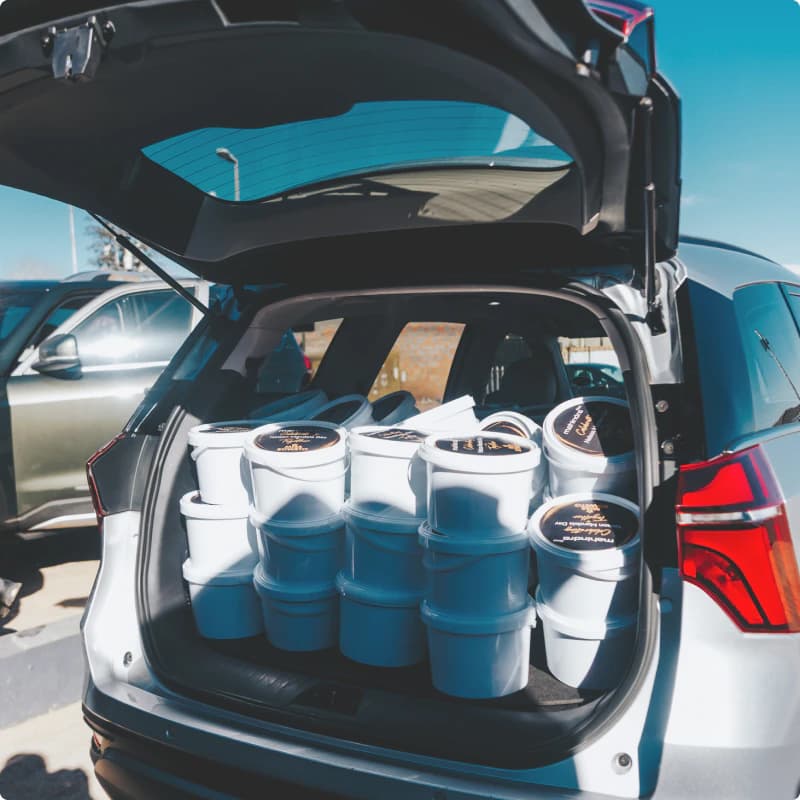 Mahindra vehicle boot filled with branded Mandela Day donation buckets